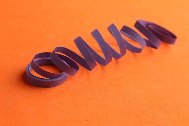 purple party streamer isolated orange background