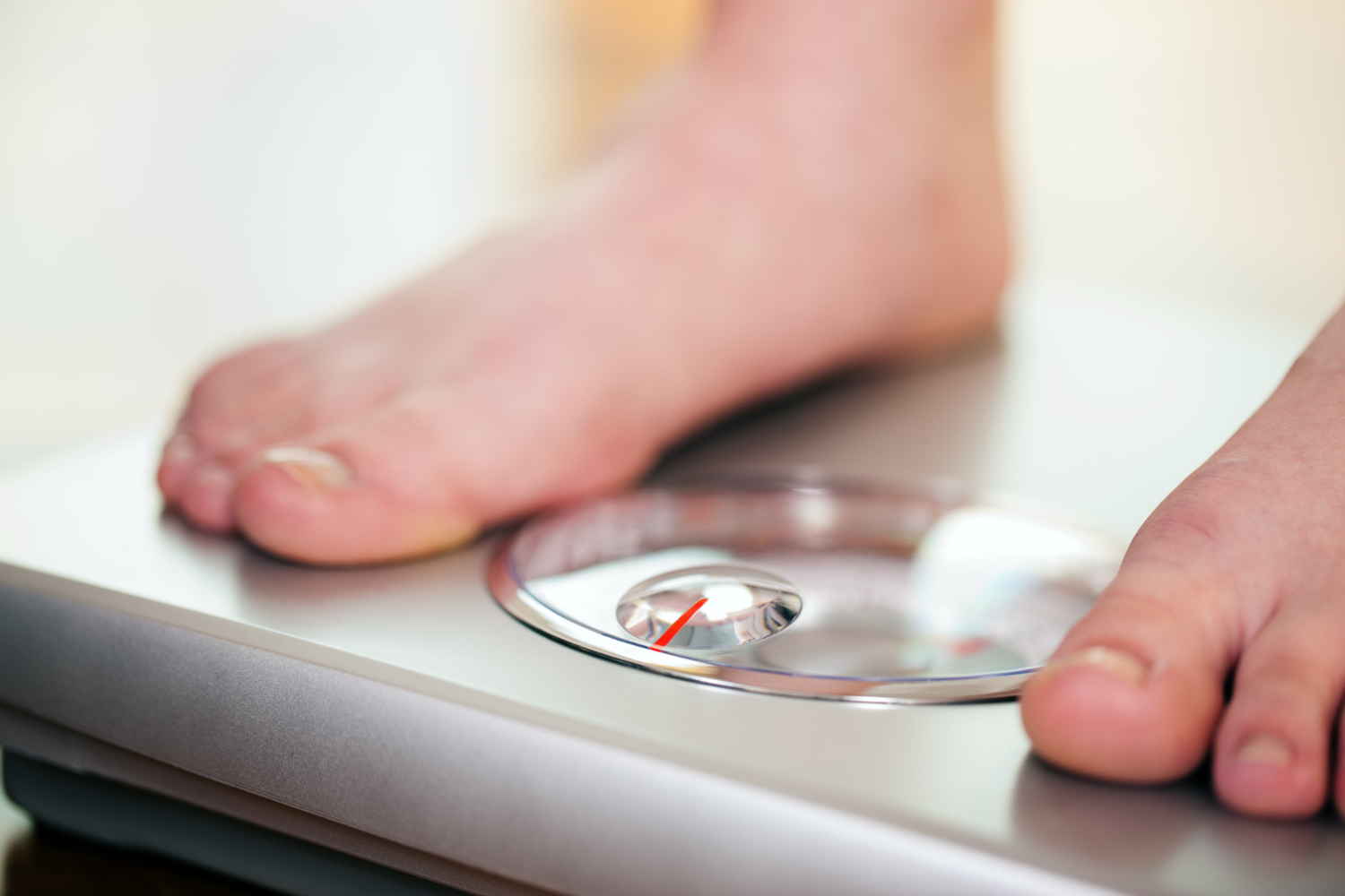 woman standing bathroom scale
